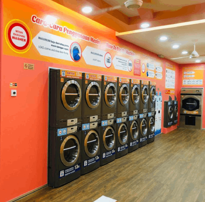 Bright orange laundromat with a wall of stacked coin-operated machines